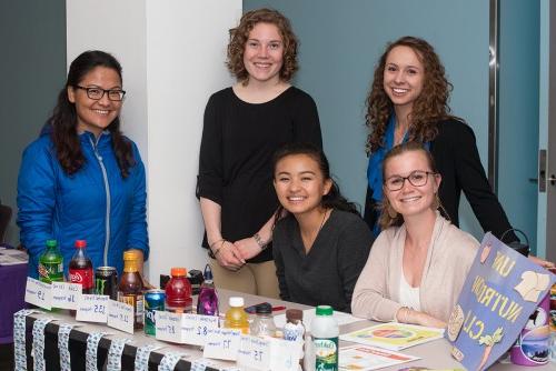 Nutrition students have a table of at a U N E health fair